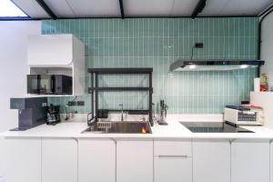 a kitchen with white cabinets and a sink at Stylish 3 Bedroom Villa with Garden, Chalong - by PoshSaga in Chalong  +67 photos
