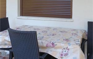 a table and two chairs with a table and a table at Gorgeous Apartment In Palit in Palit +13 photos