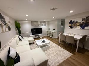 a living room with a white couch and a table at Modern loft 9 min from EWR in Hillside