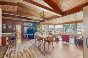 Un comedor y una sala de estar con mesa y sillas. en Hale Passage Beach House, en Gig Harbor
