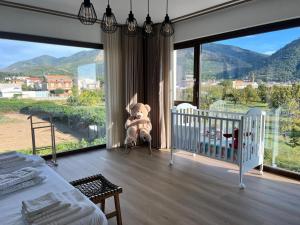a baby room with a crib and a teddy bear at Vico Suite in Santa Maria a Vico