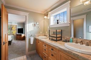 a bathroom with two sinks and a large mirror at Awbrey in Bend +32 photos