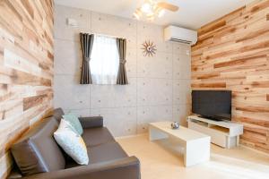 a living room with a couch and a television at Grandioso OKINAWA VILLA ONNA 5A - Vacation STAY 97721 in Meta