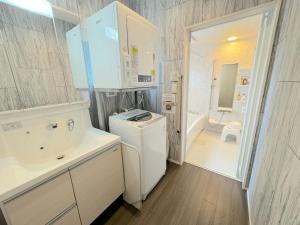 a white bathroom with a washer and dryer at Grandioso OKINAWA VILLA ONNA 5A - Vacation STAY 97835 in Meta +38 photos