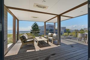 a patio with chairs and a table on a deck at Villa Super VIP | 4 pers. (Villa 68) in Ouddorp