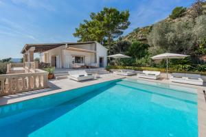 a swimming pool in front of a villa at Villa Bonjour in El Port