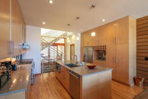 a kitchen with wooden cabinets and a counter top at ALOFT in Hood River