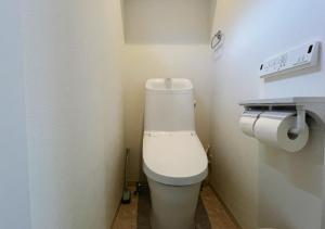 a bathroom with a white toilet in a room at 大阪第一站 in Osaka +25 photos