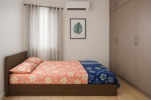 a bedroom with a bed and a cabinet at Bhakti Bliss Homestay - New Luxury 2bhk apartment in Tirupati with Kitchen and car parking in Tirupati