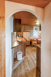 a kitchen and dining room with an archway in a house at Otto&#039s Skihütte in Sölden