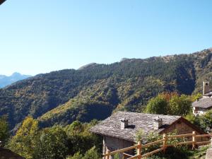 a view of a mountain with houses and trees at Nebin - casa vacanze Valle Maira in Stroppo +3 photos