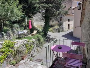 a small purple table and chairs on a balcony at Gite De Pascal Et Virginie in Ponet-et-Saint-Auban +5 photos