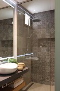 a bathroom with a sink and a glass shower at YMY Beach House in Agadir +28 photos