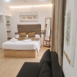 a bedroom with a large bed and a mirror at GO&REST Apartments in Valencia