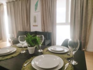 a dining room table with plates and wine glasses at GO&REST Apartments in Valencia +22 photos