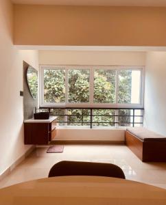 a bedroom with a large window and a bed at Family 3 BHK Residency Top Spots, Falnir Mangalore in Mangalore