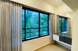 a room with a large window with a counter and a sink at Family 3 BHK Residency Top Spots, Falnir Mangalore in Mangalore