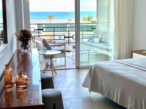 a bedroom with a bed and a view of the ocean at Gandia Tropicana Suite in Playa de Gandia +35 photos