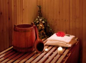 a sauna with a barrel and a towel and candles at Pakruojis Manor's Palace Boutique Hotel in Pakruojis