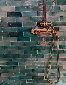 a hose hooked up to a brick wall at Turquoise Brick Surf House in Essaouira +14 photos