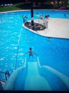 um homem numa piscina com um tubarão na água em Estudio J-60, terraza & 1º planta em Benalmádena