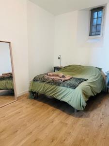 a woman laying on a bed in a room at City Loft Valence hyper-centre in Valence
