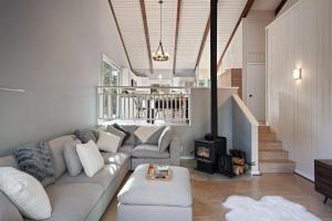 a living room with a couch and a fireplace at Pine Knoll in Bend