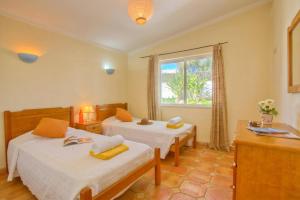 a hotel room with two beds and a window at Villa Flor by Villa Plus in Guia +15 photos