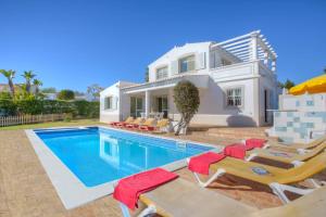 a villa with a swimming pool and a house at Villa Flor by Villa Plus in Guia