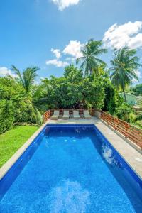 a swimming pool in the backyard of a villa at Pear Tree House Barbados in Saint James