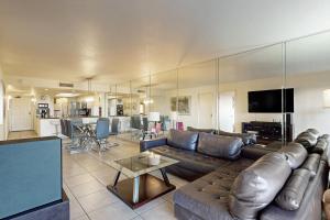 a living room with a leather couch and a table at Saida Tower IV #4103 in South Padre Island