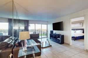 a living room with a couch and a bed at Saida Tower IV #4103 in South Padre Island