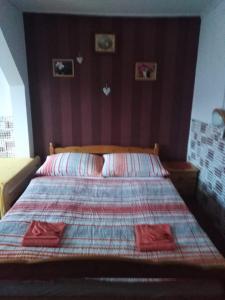 a bed with two red towels on it in a bedroom at Pension Mikulka in Mikulov v Krušných Horách