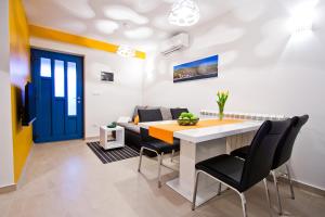 a living room with a table and chairs and a couch at Seaview Pool House Mytilus - Happy Rentals in Trgetari