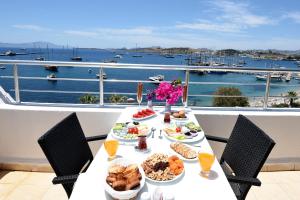a table with food on it with a view of the water at Mia Hill Suites in Bodrum City