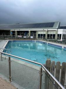 a large swimming pool in front of a building at Sunshine Lodge Haven Lakeland in Flookburgh