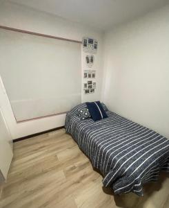 a small bedroom with a bed in the corner at Hispalis hostel in Coquimbo