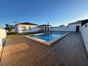 a large backyard with a swimming pool and a house at Orchard View in Campano