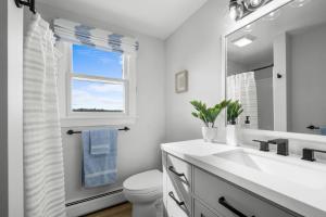Un baño blanco con lavabo y ventana en 116 Salt Marsh Road East Sandwich- Ocean's End, en East Sandwich 56 fotos más