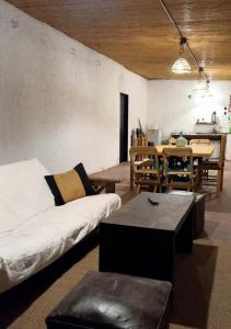a living room with a white couch and a table at El Rincón de las Palmas in Cafayate +23 photos