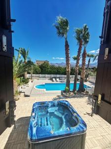a hot tub in the middle of a courtyard with palm trees at Villa Girolama in Tonnara di Bonagia +77 photos