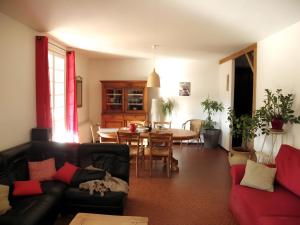 a living room with a couch and a table at L'arbre Du Magnan - Gîte En Ardèche in Chandolas