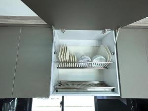 an open refrigerator with plates and dishes in it at House 10 minutes from the airport, Rionegro in Rionegro +26 photos