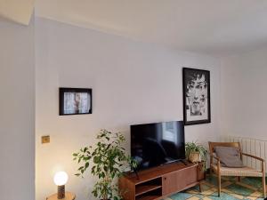 a living room with a flat screen tv on a wall at Casa rural El Moral by Fuentelgato in Huerta del Marquesado