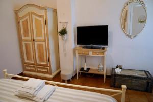 a bedroom with a bed and a television on a table at Piccolo Paradiso - Montenero in Montenero