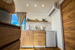 a small kitchen with a sink and a refrigerator at Houseboat Toruń in Toruń +7 photos