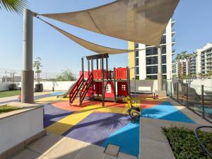 a playground with a slide in a building at Elite Escape - Getaway in Azizi Riviera 29 in Dubai