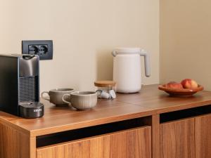 a kitchen counter with a microwave and a coffee maker at Numa Rome Barberini in Rome +48 photos