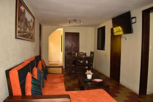 a living room with a couch and a table at El Rinconcito de la Antigua in Antigua Guatemala