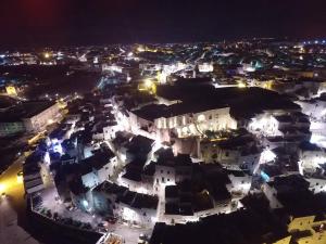 an aerial view of a city at night at 30 Metri Quadri in Ostuni